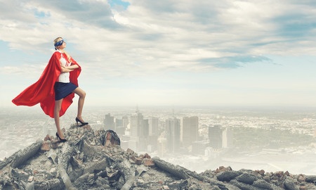 37811536 - young confident woman in red cape and mask